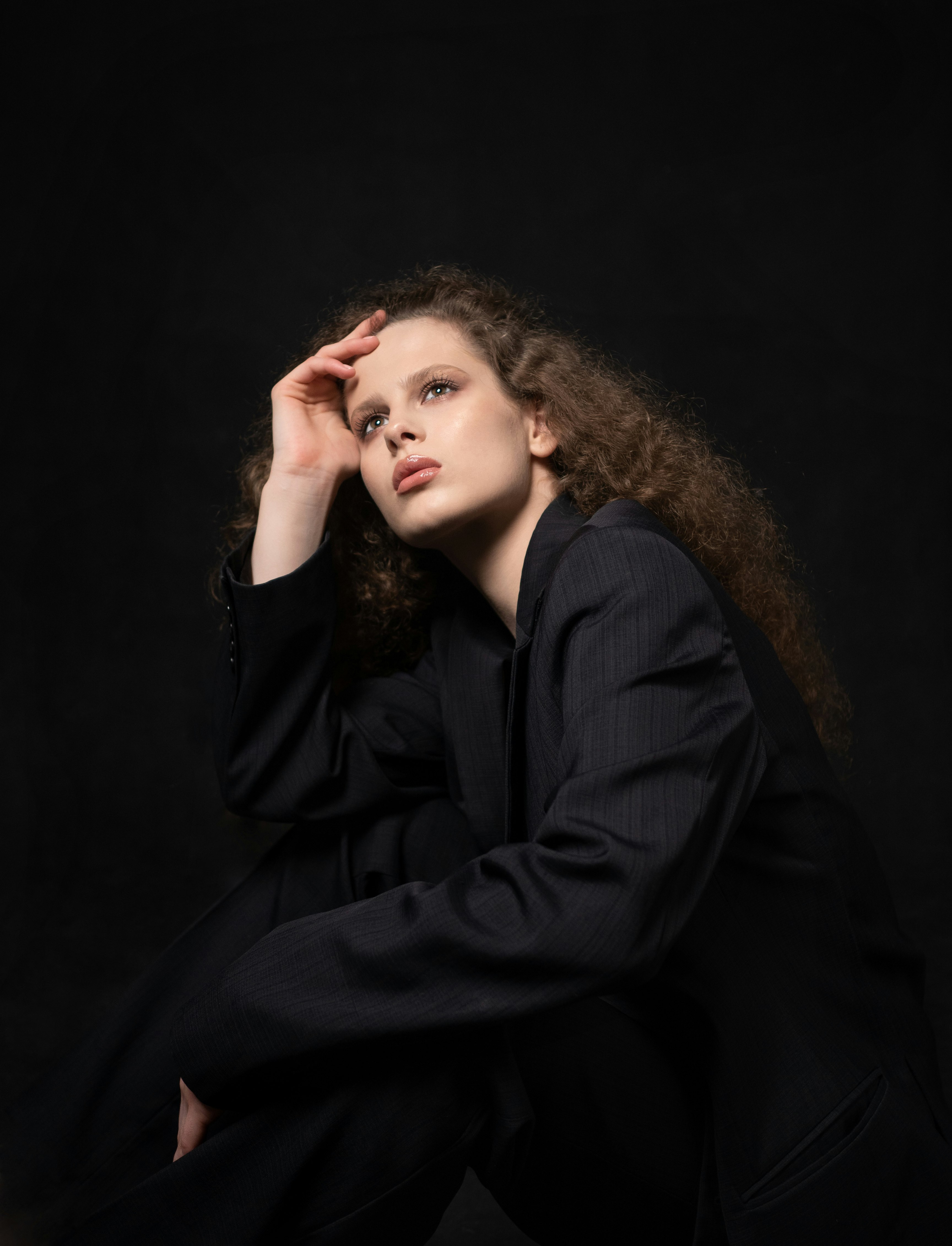 woman in black blazer with brown hair